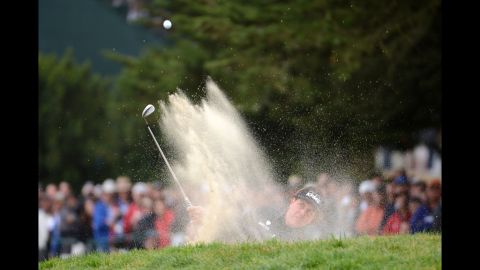 Mickelson blasts out of the bunker on the 10th hole.