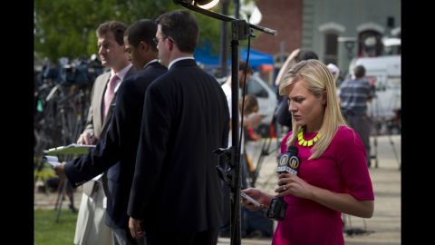 Reporters wait with microphones outside of the Sandusky trial. 