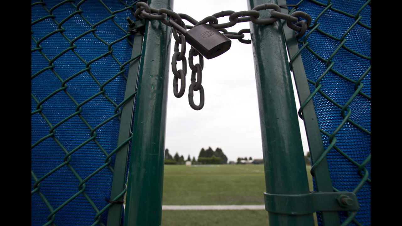 The gate to the practice football field is locked at the Mildred and Louis Lasch Football Building at Penn State University in State College, Pennsylvania