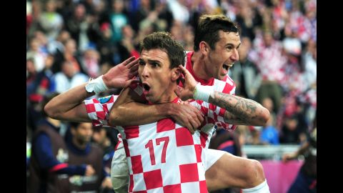 Croatia's Mario Mandzukic and his teammate Darijo Sma celebrate the team's game-tying goal against Italy in Poznan, Poland, on Thursday, June 14. 
