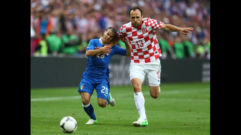 Gordon Schildenfeld of Croatia and Sebastian Giovinco of Italy battle for the ball.