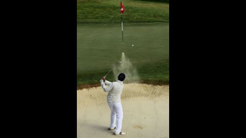 Andy Zhang, a 14-year-old originally from China, hits a bunker shot on the second hole.