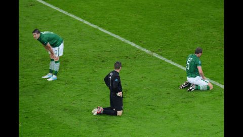Sean St Ledger, Shay Given and  Richard Dunne of Republic of Ireland sit dejected after Fernando Torres of Spain scored Spain's third goal during the Spain-Ireland match.