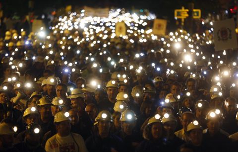 The streets of Leon in northern Spain light up as thousands of coal miners march with their helmet lights on. The protest on June 12, 2012 was part of a nationwide miners' strike against subsidy reductions.