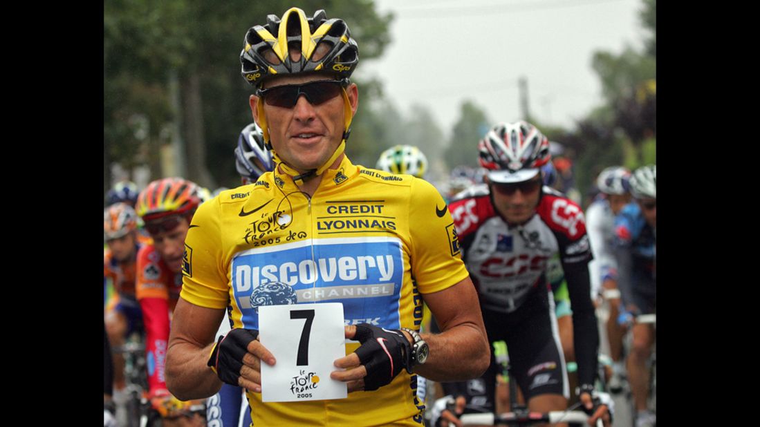 Armstrong holds up a paper displaying the number seven at the start of the Tour de France in 2005. He went on to win his seventh consecutive Tour de France.