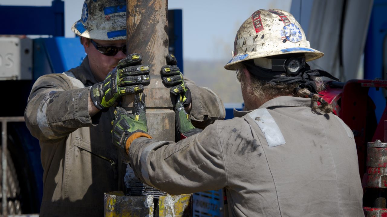 Workers change pipes at drilling rig exploring the Marcellus Shale outside the town of Waynesburg, Pennsylvania on April 13.