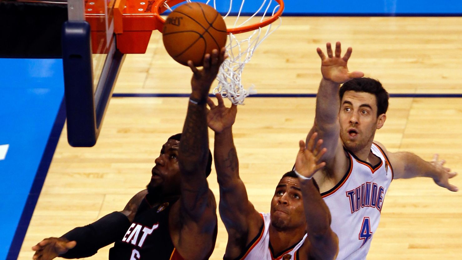 The Miami Heat's LeBron James goes up for a shot against Oklahoma City's Nick Collison and Thabo Sefolosha during Game 2 of the 2012 NBA Finals. 