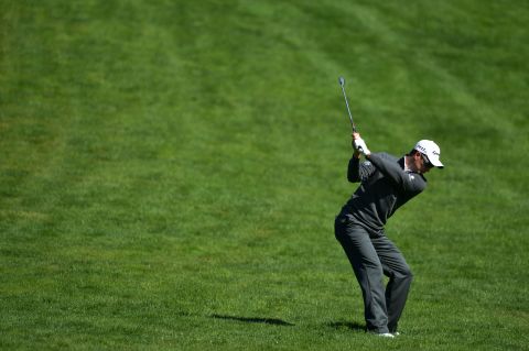 Justin Rose of England hits an approach shot on the fourth hole.