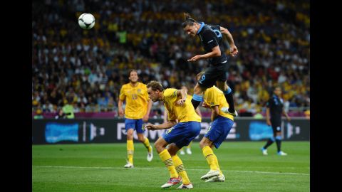 Andy Carroll of England heads the first goal during the match between Sweden and England.