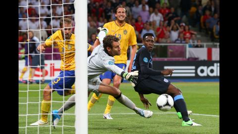 Danny Welbeck of England scores the third goal past Andreas Isaksson of Sweden.