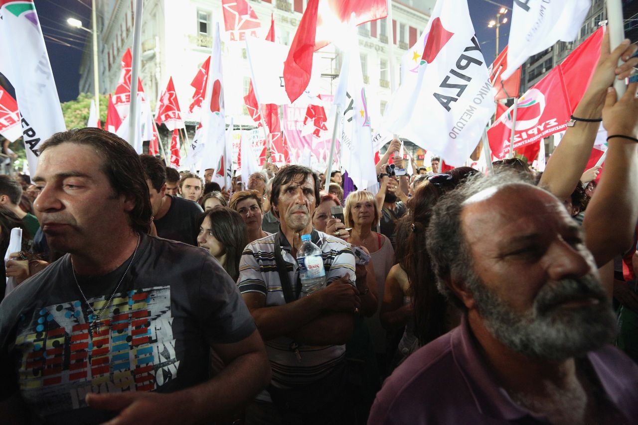 Supporters of the anti-austerity package Syriza party wave flags during a rally ahead of Sunday's general election. The race between Syriza and the pro-bailout New Democracy party appears to be tight.