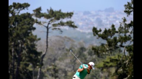 Graeme McDowell of Northern Ireland hits a shot on the first hole.