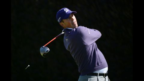 Matt Kuchar of the United States watches his tee shot on the first hole.