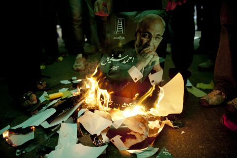 Egyptians burn the likeness of presidential candidate and former Prime Minister Ahmed Shafik in Cairo on Friday, the eve of the nation's presidential election.