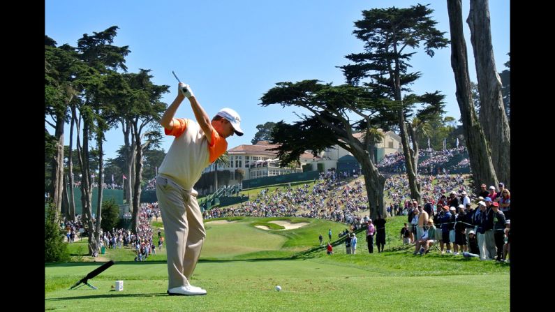 David Toms of the United States hits his tee shot on the eighth hole.