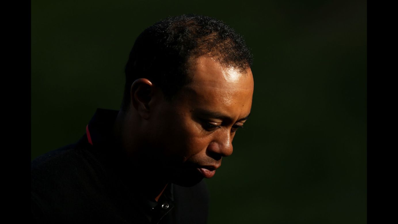 Tiger Woods walks off the 18th green.