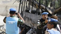 U.N. observers photograph a bus bombed outside a Shiite holy shrine in the Syrian capital, Damascus, on June 14.