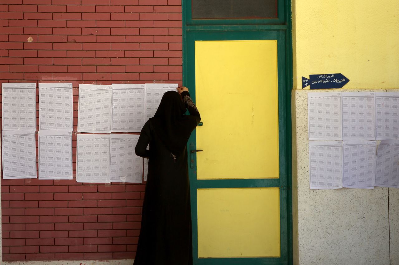 A veiled Egyptian woman looks for her name on the registered voters' list in the city of Zagazig.