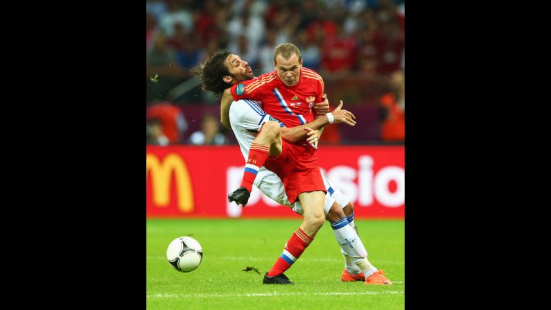 Aleksandr Anyukov of Russia and Georgios Samaras of Greece battle for the ball during the group A match between Greece and Russia.