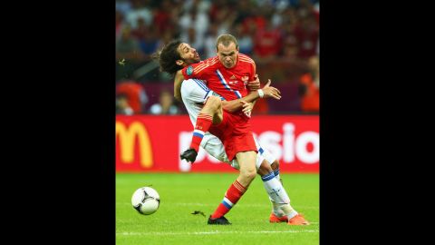 Aleksandr Anyukov of Russia and Georgios Samaras of Greece battle for the ball during the group A match between Greece and Russia.