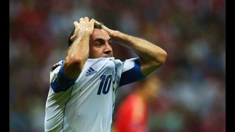 Giorgos Karagounis of Greece reacts after he receives a yellow card for diving from referee Jonas Eriksson during the match between Greece and Russia.