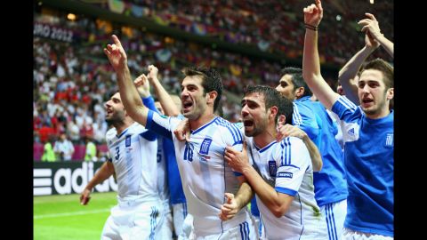 Giorgos Karagounis of Greece, center, celebrates Greece's victory over Russia and and adnvancement to the quarter finals during the match between Greece and Russia.