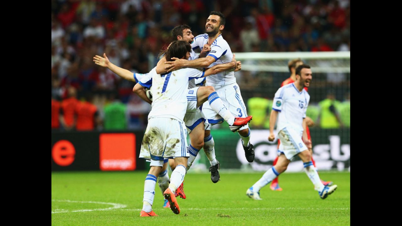 Georgios Samaras, Giannis Maniatis and Giorgos Tzavelas of Greece celebrate victory during the match between Greece and Russia on Saturday, June 16.