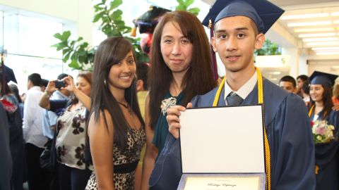 Rodrigo Espinoza with his mother, Marcela, and sister Jacqueline at the graduation ceremony of Hector P. Garcia High School.