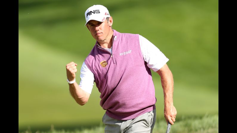 Lee Westwood of England celebrates his birdie putt on the 18th hole Saturday.