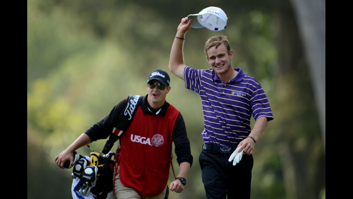 John Peterson of the United States celebrates a hole-in-one on the 13th hole with his caddie, Gentry Mangun.
