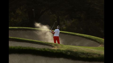 Raphael Jacquelin of France hits a bunker shot on the 17th hole during the third round.