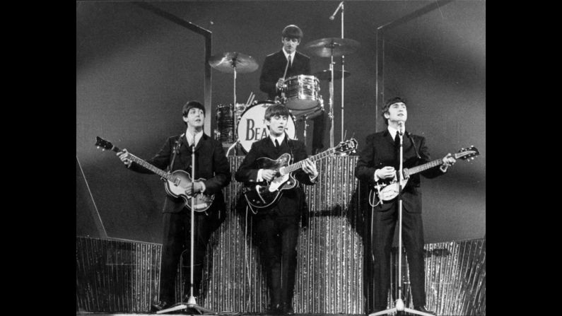 The Beatles, whose arrival in the U.S. in 1964 set off "Beatlemania," perform on stage at the London Palladium in 1963.
