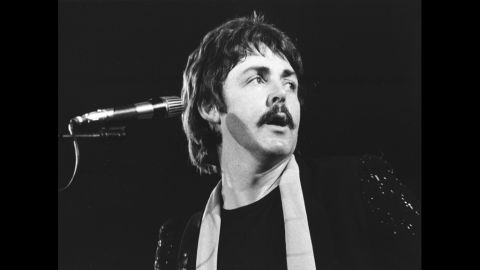McCartney performs in 1976 with the band Wings, which he formed after The Beatles disbanded in 1970.