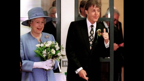 McCartney poses wtih Queen Elizabeth II at the Liverpool Institute for Performing Arts in 1996.
