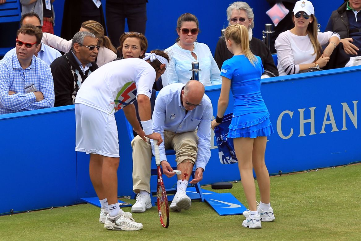 David Nalbandian shows his concern after line judge Andrew McDougall is left with a gashed leg.