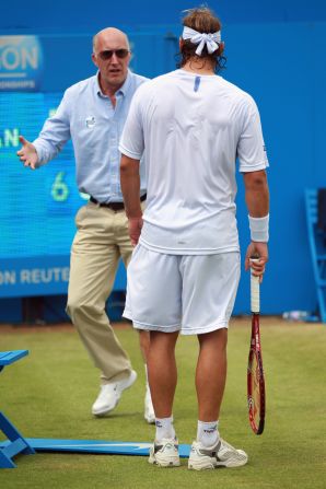 Line judge McDougall remonstrates with Nalbandian after the Argentina star's ill-judged kick left him with a gashed leg.