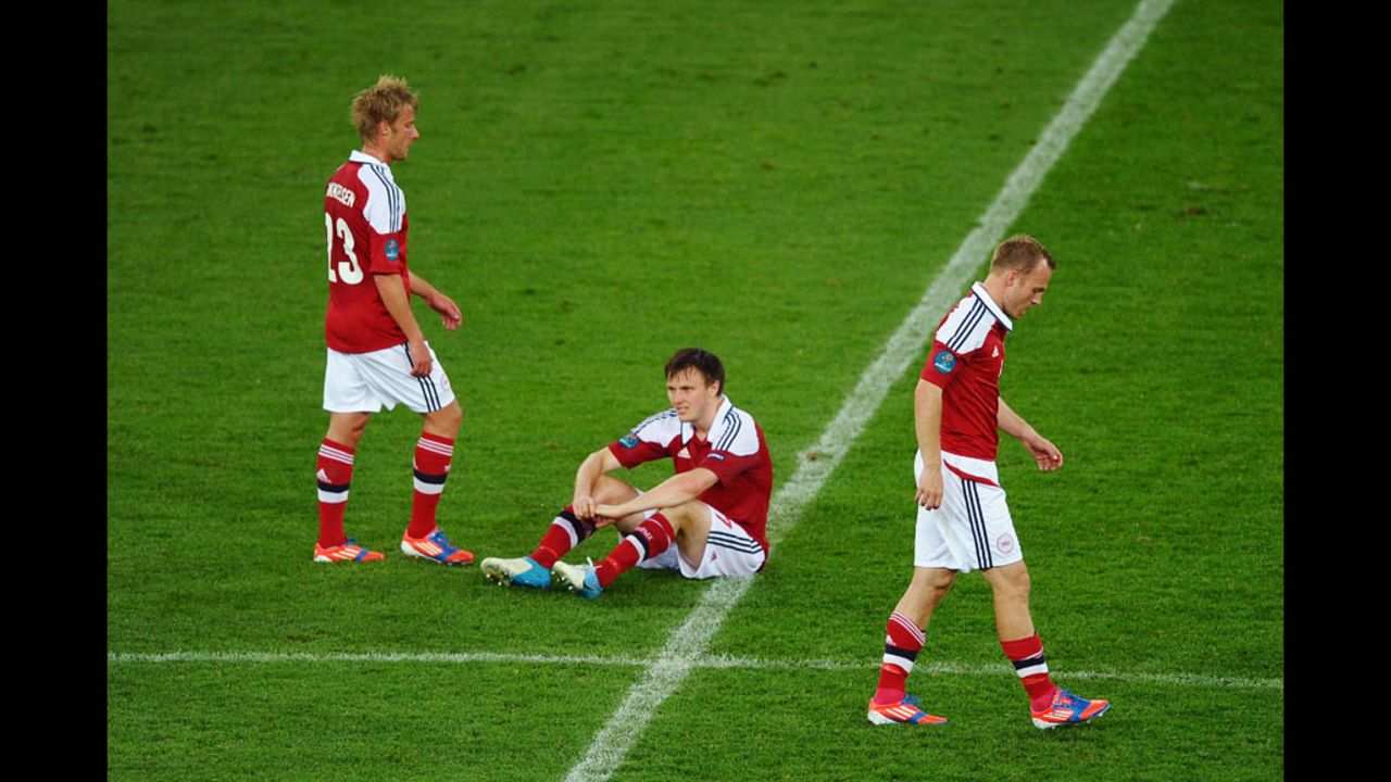 Jores Okore, William Kvist and Lars Jacobsen of Denmark face defeat in the match against Germany on Sunday.