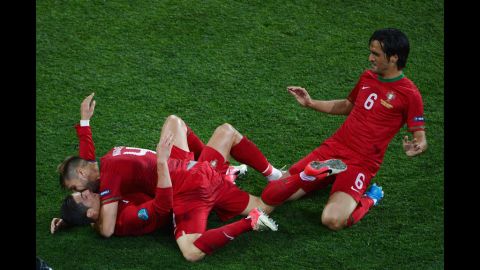 Portugal's Cristiano Ronaldo, bottom left, celebrates with teammates Miguel Veloso and Custodio after scoring the team's second goal against the Netherlands.