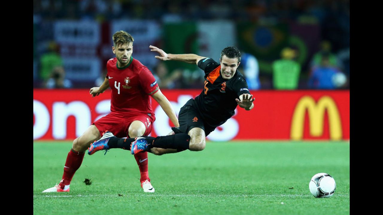 Miguel Veloso of Portugal challenges Robin van Persie of the Netherlands on Sunday.