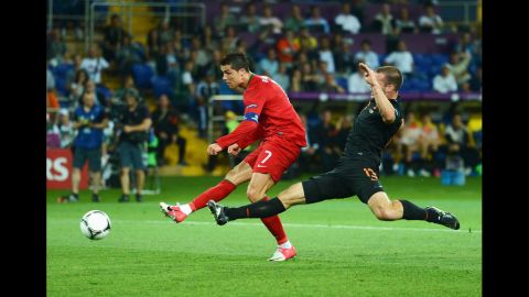 Portugal's Cristiano Ronaldo kicks the ball past a Dutch defender during Sunday's match.