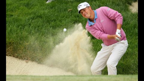 Fredrik Jacobson of Sweden plays a bunker shot on the second hole.