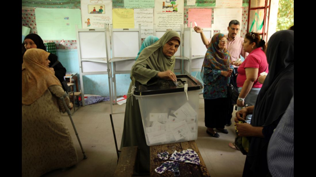 Women line-up to cast their vote at a polling station in Cairo on Sunday.