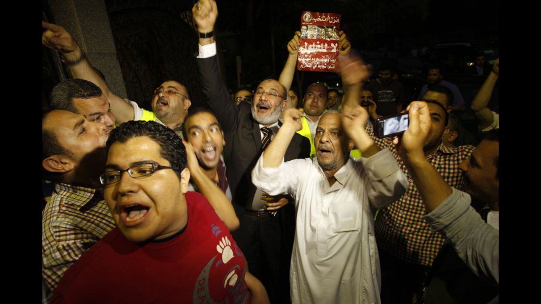Morsi supporters celebrate Monday in Cairo. Votes in the Egyptian capital, the largest population center, continued to be tallied, but unofficial results by a state-run news website showed Morsi leading elsewhere with 11.2 million votes, compared with 10.3 million for Ahmed Shafik, the last prime minister in the waning days of Mubarak's regime.