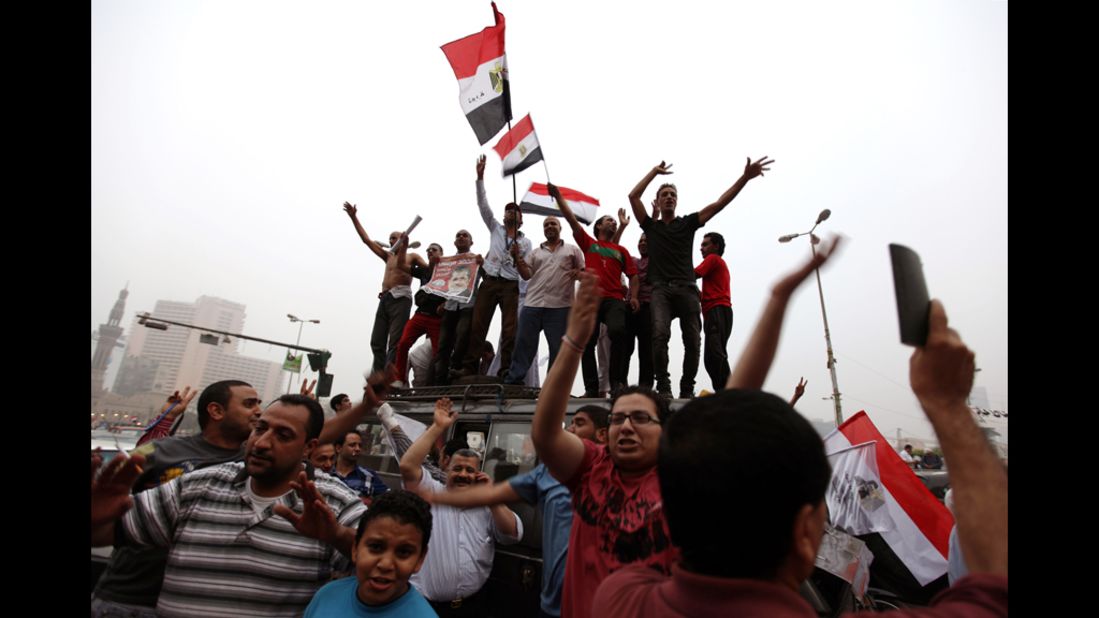 Morsi supporters wave flags Monday in Cairo's Tahrir Square after the Islamists claimed victory.  The square was considered the heart of the February 2011 uprising that led to Hosni Mubarak's downfall.