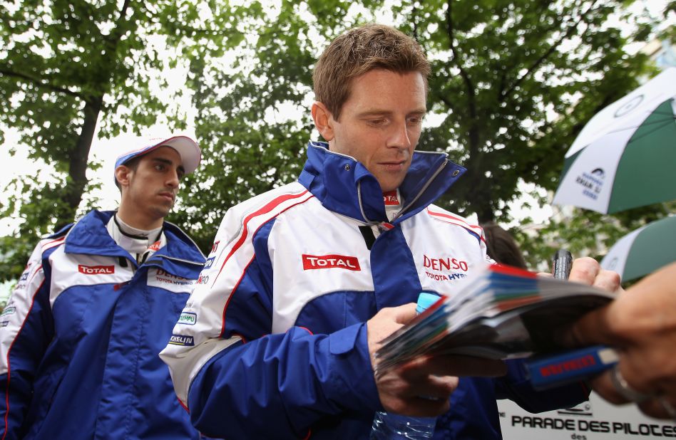 Toyota driver Anthony Davidson, seen here signing autographs pre-race, was involved in a horrific crash during the race. The Briton broke his back, and admitted he felt lucky to be alive after the incident.