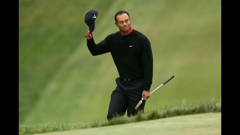 Tiger Woods of the United States waves to the crowd on the 18th green.