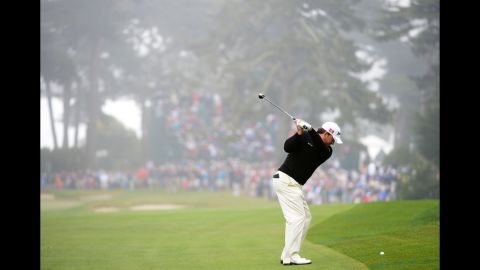 Graeme McDowell hits his second shot on the sixth hole.