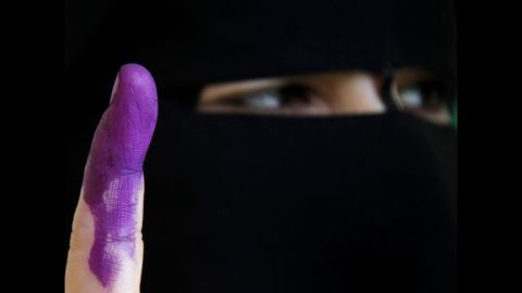 An Egyptian woman shows her ink-stained finger, marking that she voted in Cairo on Sunday.