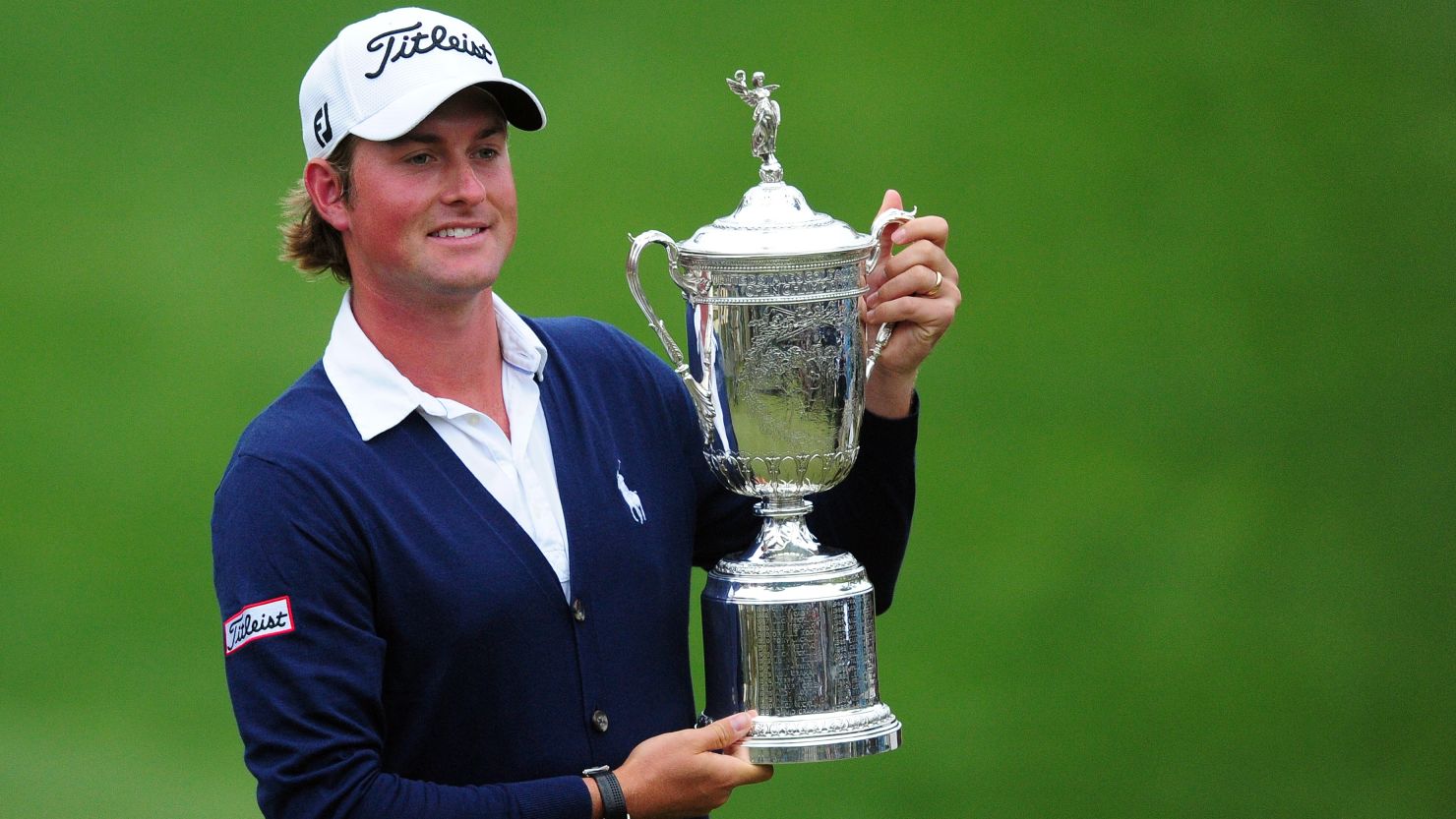 Webb Simpson holds his championship trophy after winning the 112th U.S. Open but will not be at the British Open.