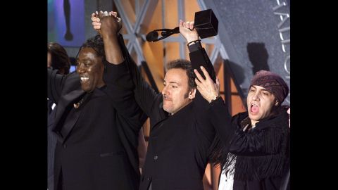Springsteen celebrates with Clarence Clemons, left, and Steven Van Zandt of the E Street Band after being inducted into the Rock and Roll Hall of Fame at a 1999 event in New York.